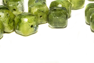 Beautiful green jade beads in macro photography, perfect for crafting and jewelry design. Decorative faceted square shape jade stone beads for boho jewelry. 