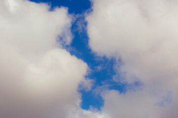 White heap clouds in the blue peaceful sky. The concept of psychological calmness and health. Peace of mind with the forces of nature. Air travel concept.