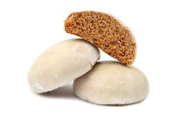 Pastry buns glazed with sugar icing in group with halved piece. Christmas pastry isolated on white.