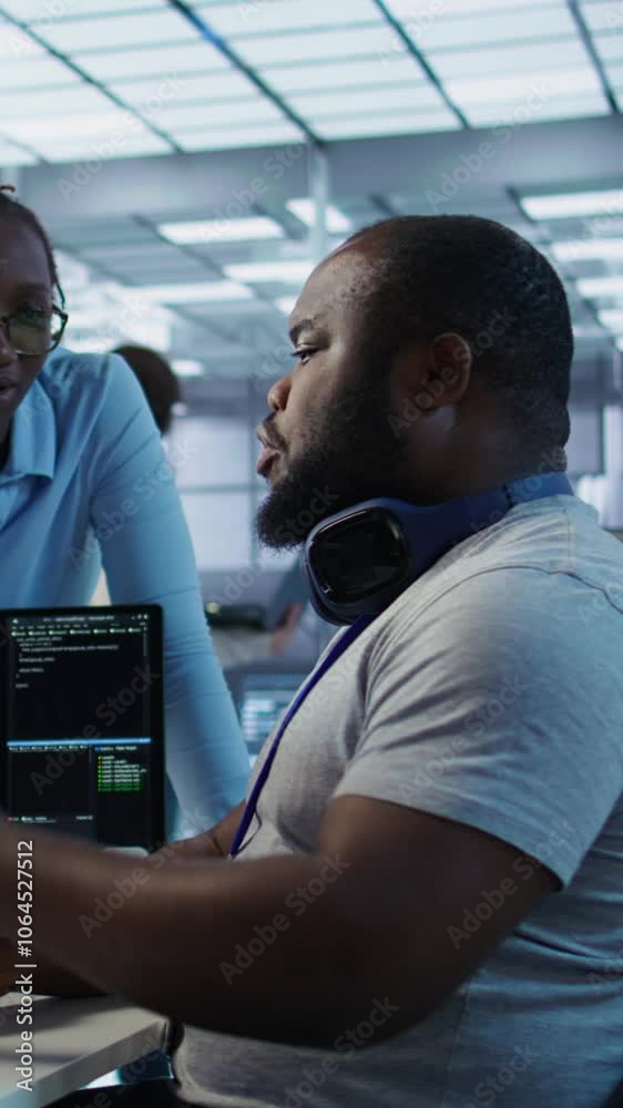 Aufkleber system administrator working with colleague in data center providing computing resources for differe
