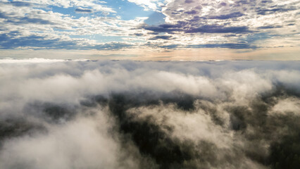 Obraz premium Flying above the clouds at dawn in autumn