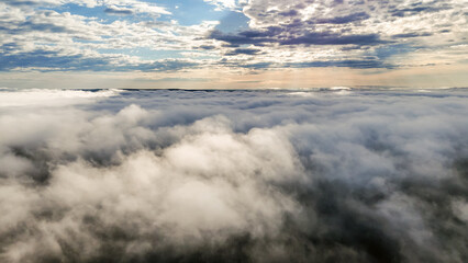 Obraz premium Flying above the clouds at dawn in autumn