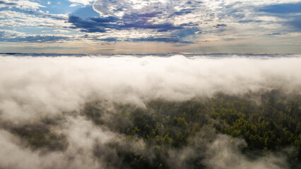 Obraz premium Flying above the clouds at dawn in autumn