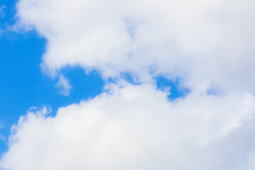 White heap clouds in the blue peaceful sky. The concept of psychological calmness and health. Peace of mind with the forces of nature. Air travel concept.