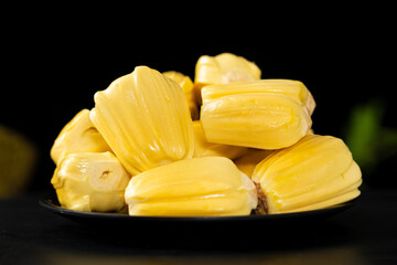 Ripe jackfruit peeled tropical fruit on table.
