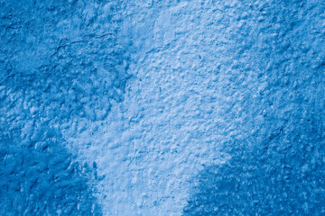 Grunge classic blue concrete background. Textured plaster wall. Creative backdrop for your design. Color of the year 2025 concept. Top view, layout for design. Surface with peeling shabby pattern.