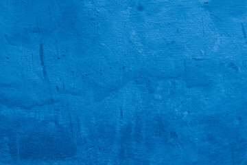 Grunge classic blue concrete background. Textured plaster wall. Creative backdrop for your design. Color of the year 2025 concept. Top view, layout for design. Surface with peeling shabby pattern.