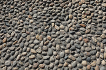 historic pedestrian paving with pebbles and smooth stones cemented