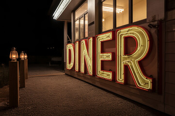 Old-fashioned neon "Diner" sign glowing in a dimly lit space