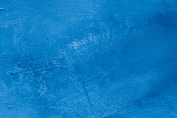 Grunge classic blue concrete background. Textured plaster wall. Creative backdrop for your design. Color of the year 2025 concept. Top view, layout for design. Surface with peeling shabby pattern.