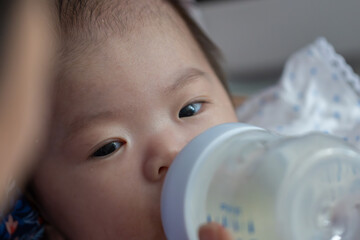 Asian baby girl drink milk from bottle,time for milk,go to the bed