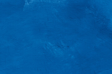 Grunge classic blue concrete background. Textured plaster wall. Creative backdrop for your design. Color of the year 2025 concept. Top view, layout for design. Surface with peeling shabby pattern.