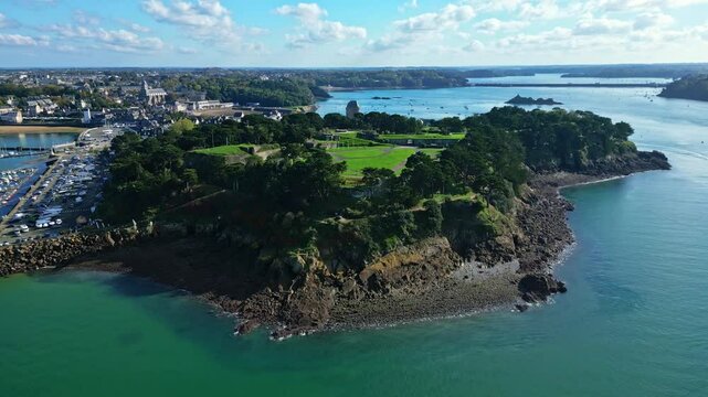 Cit&eacute; d'Alet or Aleth City with Rance tidal power station in background, Saint-Malo. Brittany in France. Aerial drone forward descending and sky for copy space