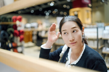 Thoughtful Woman Reflecting in a Modern Retail Space