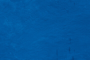 Grunge classic blue concrete background. Textured plaster wall. Creative backdrop for your design. Color of the year 2025 concept. Top view, layout for design. Surface with peeling shabby pattern.