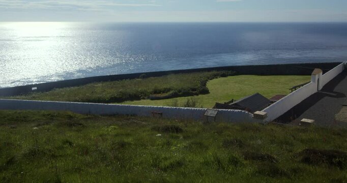 a shot of the lightkeepers gardens at the Mull of Galloway lighthouse with sea and blue sky in background