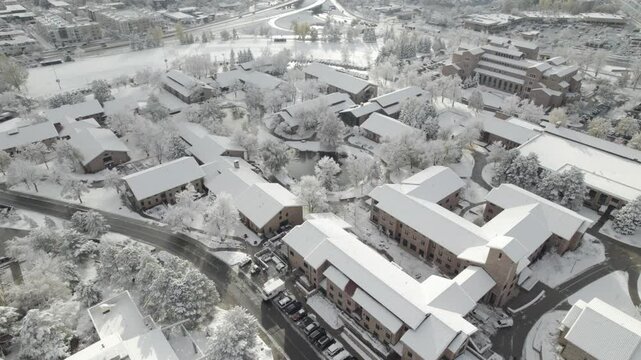 Snow covered buildings surrounding pond 4k drone footage Dlog 10 Bit ungraded