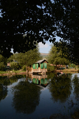 Obraz premium Wooden house by the lake. Cottage on the river bank. Cottage for rest. House in the forest