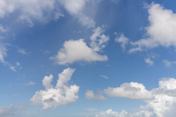 Serene Sky with Fluffy Clouds Against a Bright Blue Backdrop