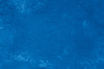 Grunge classic blue concrete background. Textured plaster wall. Creative backdrop for your design. Color of the year 2025 concept. Top view, layout for design. Surface with peeling shabby pattern.