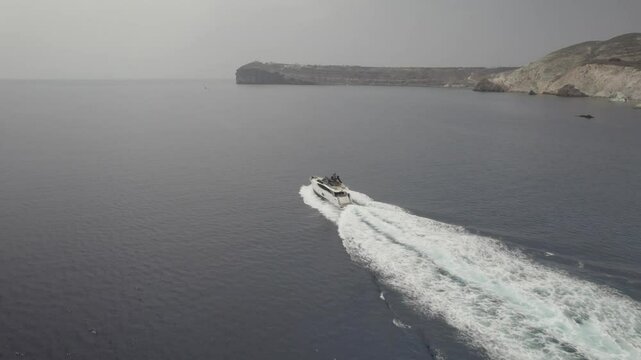 Speed boat chase in front of cliffs 4k drone footage Dlog 10 Bit ungraded
