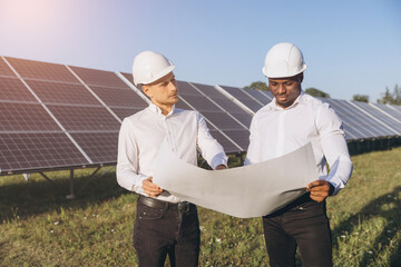 Engineers Discussing Solar Panel Project at Renewable Energy Site