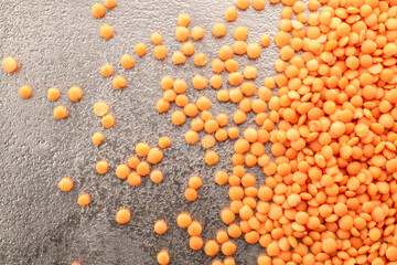 Raw red lentils on a metal tray, macro, top view.