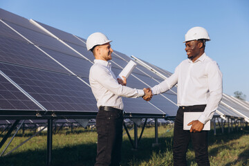 Engineers Shaking Hands at Solar Panel Installation Site