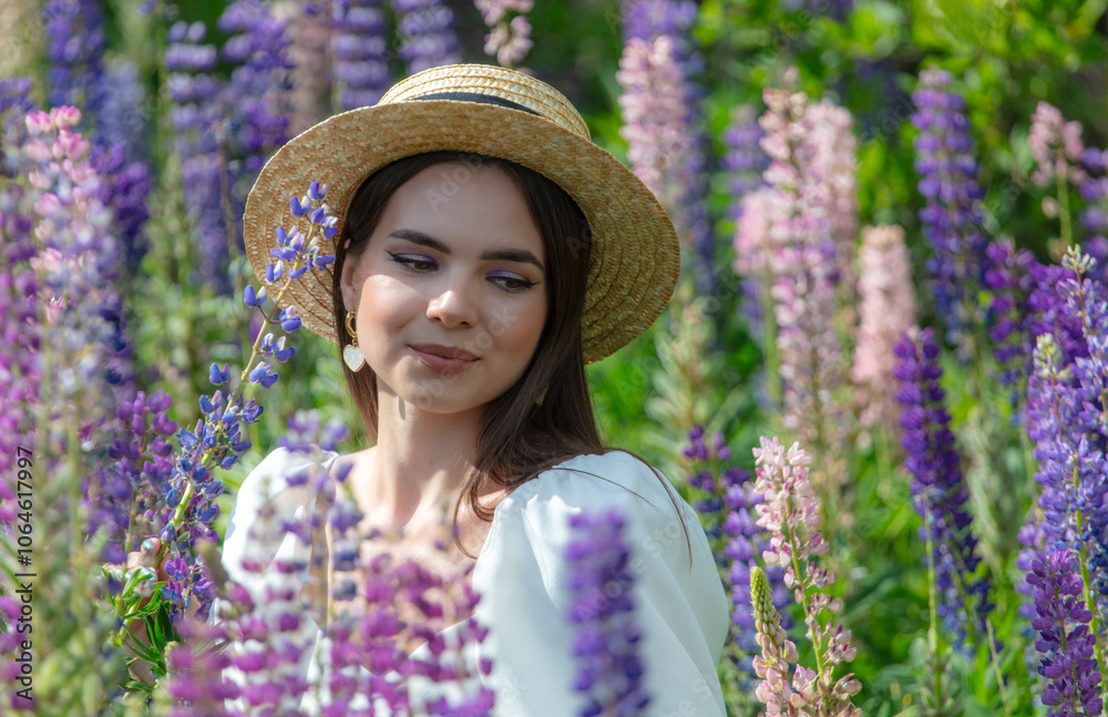 Wall mural portrait of a girl wearing a straw hat in lupine colors