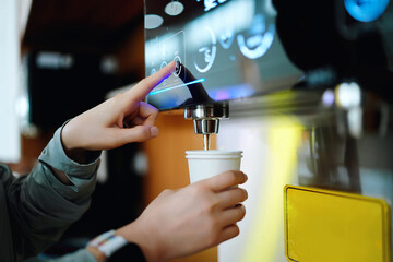 User Interacting with a Beverage Dispensing Machine in a Caf? Setting