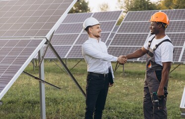 Engineers Shaking Hands at Solar Panel Installation Site