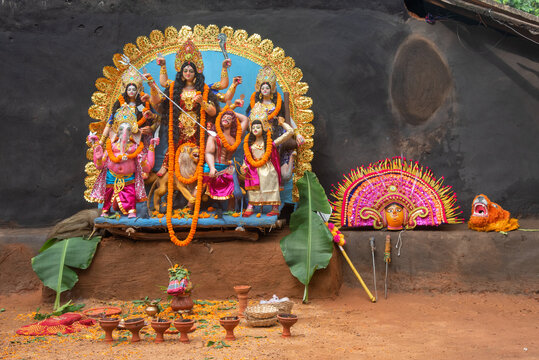 Culture of West Bengal, India in a single frame. Goddess Durga idol and chhau dance mask. Durga puja celebration. Close up, selective focus.