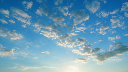 Fototapeta premium Dramatic moving white cumulus and cirrocumulus clouds or puffy fluffy cloudscape on beautiful sunny blue sky. Time lapse.