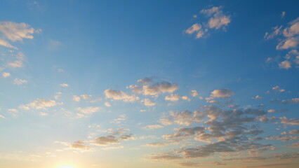 Fototapeta premium Beautiful blue sky with orange and peach clouds background. Natural sunset white and yellow clouds floating on blue sky. Time lapse.