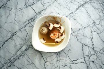 Spicy and sour soup with mushrooms and shrimp, asian food menu