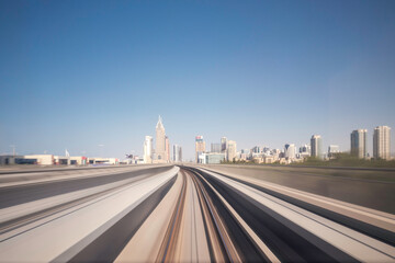 Fototapeta premium Modern driverless Dubai elevated Rail Metro System, running forward alongside the Sheikh Zayed Road.