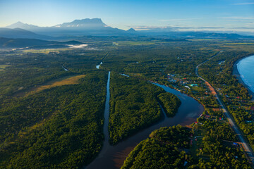 River flowing through tropical rainforest towards mount kinabalu in borneo malaysia