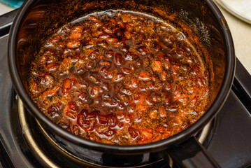 Cooked sea buckthorn berry jam in a saucepan.