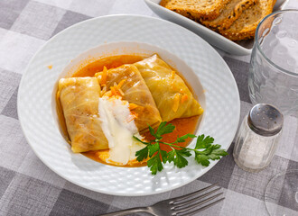 World famous dish is cabbage rolls served with sour cream and decorated with greenery
