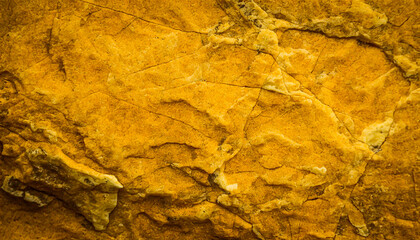 Yellow rock background. Cracked and weathered stone