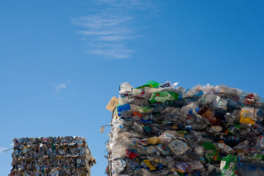Compacted recycled plastic, stacked bales of processed plastic for recycling processing