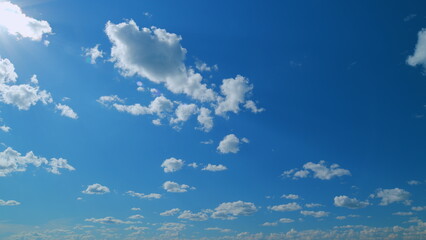 Blue heaven summer cloudscape. Rolling puffy white clouds are moving. Time lapse.