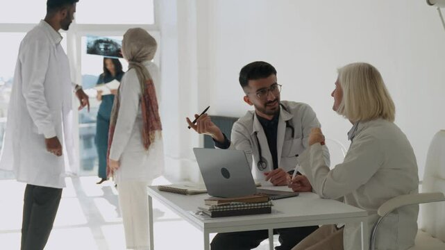 Doctor, hospital with medical, discussion and explaining the prescription, healthcare and work. Medicine, workplace, male and colleagues with diagnosis and working together, talk or agree, x-ray check