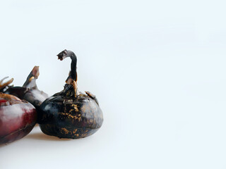 Unpeeled whole fresh raw Chinese water chestnut or water nut in plain white background, medicine fruit, vegetable tasty ingredients, food from nature