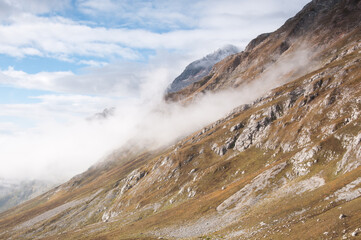 Rocky slopes of Fisht-Oshten massif covered with fog in the morning, Republic of Adygea, Russia