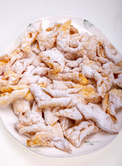 Angel wings (Faworki), cakes. Sweet pastry deep fried and sprinkled with powdered sugar
