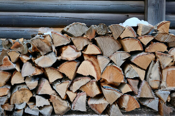 Background of stacked logs stored for fire making