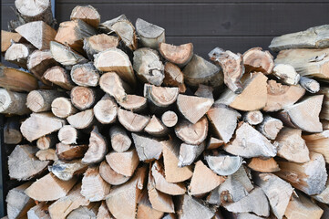 Background of stacked logs stored for fire making