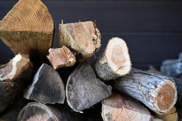 Background of stacked logs stored for fire making