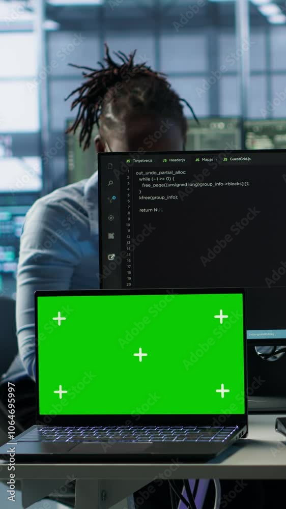 Poster isolated screen laptop next to programmer coding in server farm while listening music in headphones.